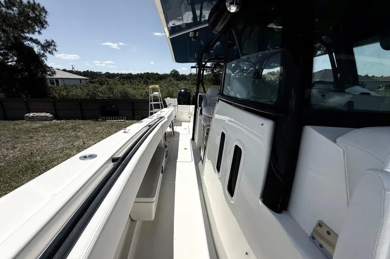 Slide: The Image of 2017 HCB 42 Siesta boat, side view, showcasing sleek design and spacious deck. - 60