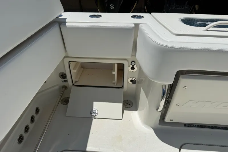 Slide: The Image of Interior view of a 2017 HCB 42 Siesta boat, featuring storage compartments. - 64