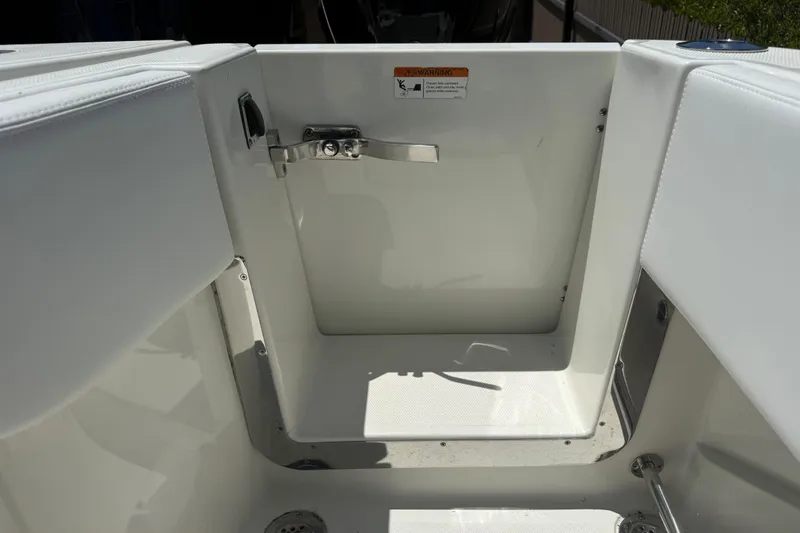 Slide: The Image of 2017 HCB 42 Siesta boat interior with white seating and storage compartment. - 65