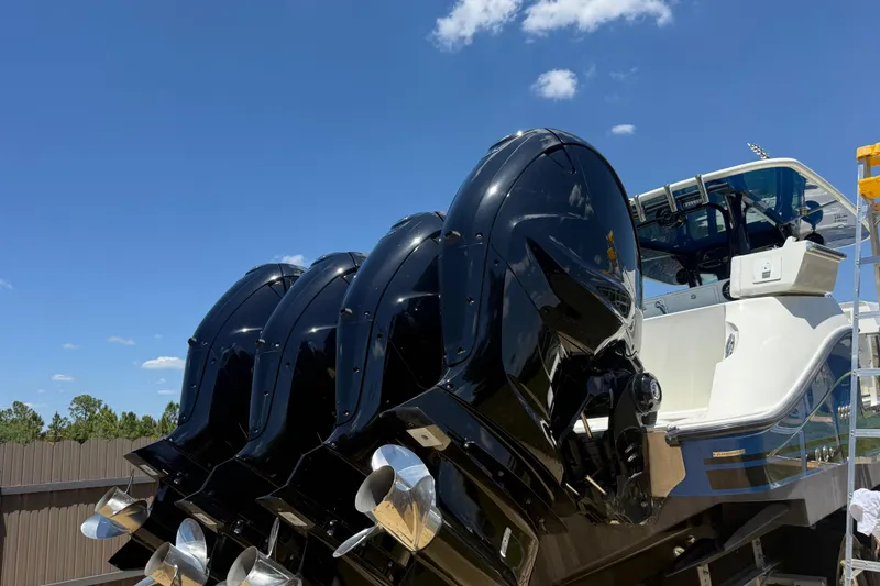 Slide: The Image of 2017 HCB 42 Siesta boat with four powerful outboard engines under a clear blue sky. - 66