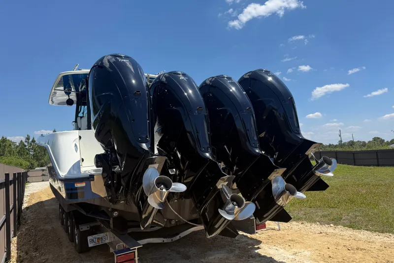 Slide: The Image of 2017 HCB 42 Siesta boat with four powerful outboard engines on a trailer. - 68