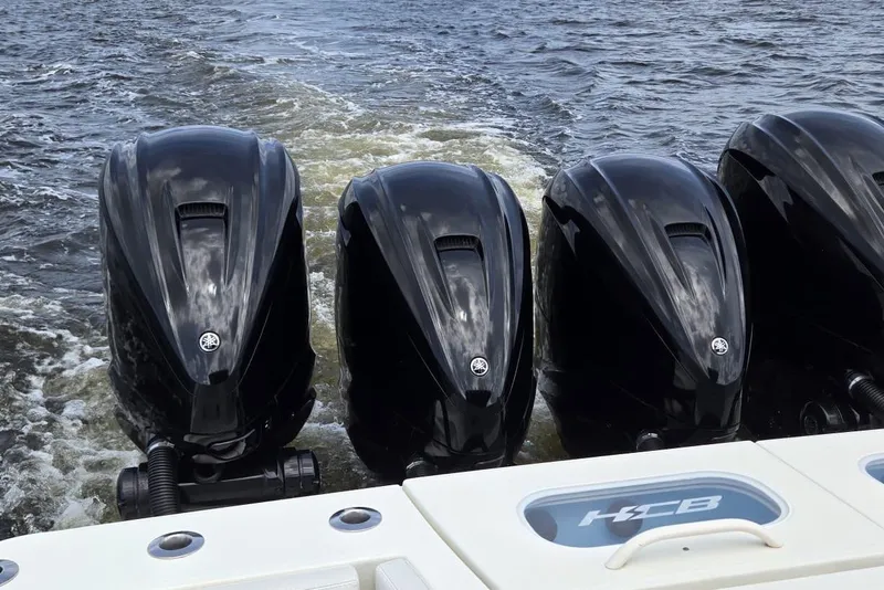 Slide: The Image of Four powerful outboard engines on a 2017 HCB 42 Siesta boat in motion. - 73