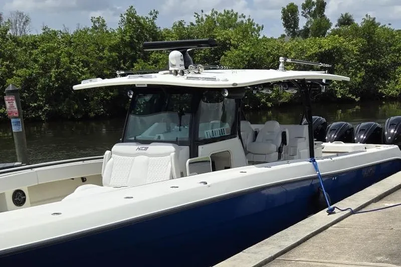Slide: The Image of 2017 HCB 42 Siesta boat docked, featuring sleek design and multiple engines. - 74