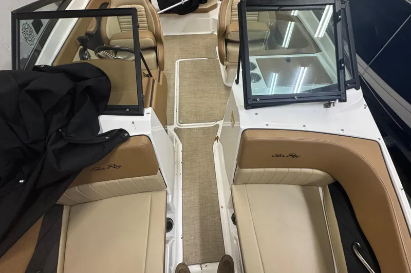 Slide: The Image of 2018 Sea Ray SPX 210 Outboard boat interior with tan seating and speakers. - 10