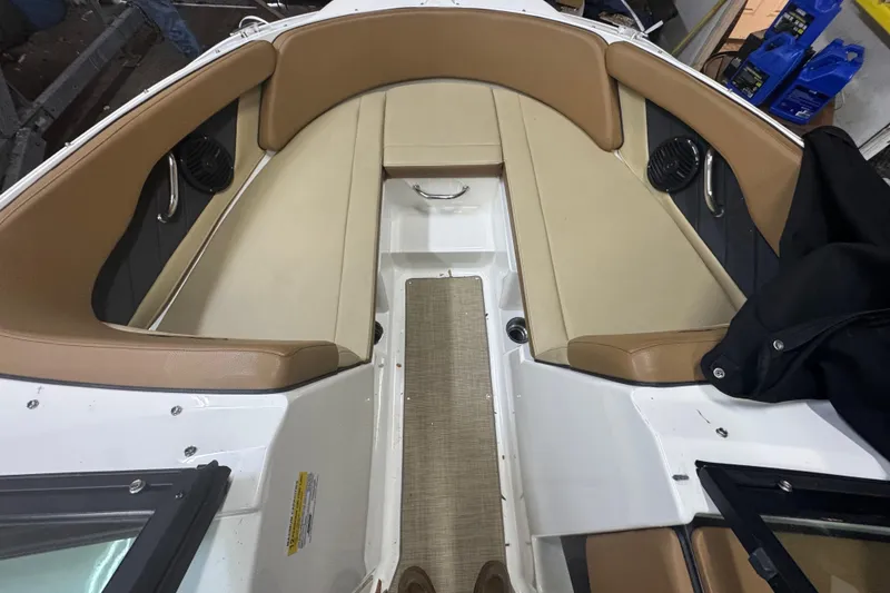 Slide: The Image of 2018 Sea Ray SPX 210 Outboard interior with beige seating and fire extinguisher. - 11