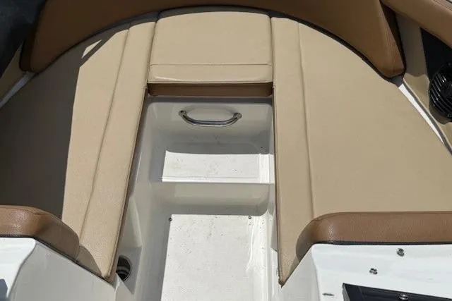 Slide: The Image of 2018 Sea Ray SPX 210 Outboard boat interior with tan seating and storage compartment. - 14