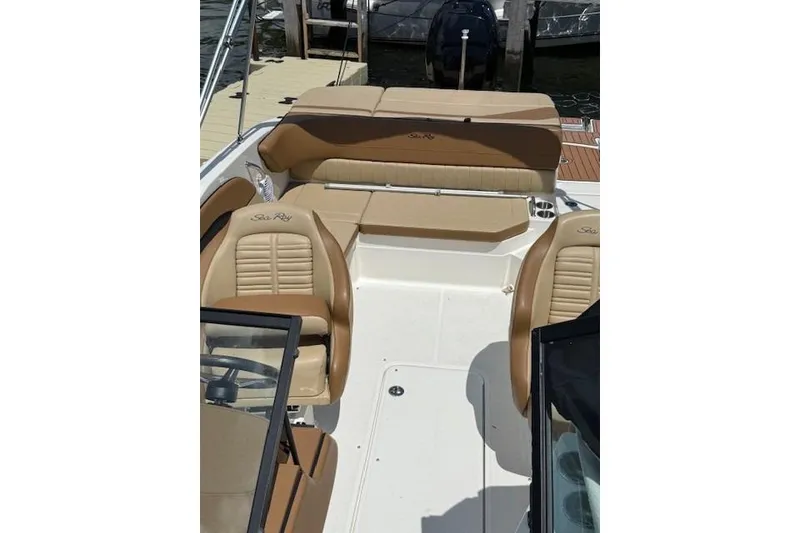 Slide: The Image of 2018 Sea Ray SPX 210 Outboard boat interior with tan seating and sleek design. - 16