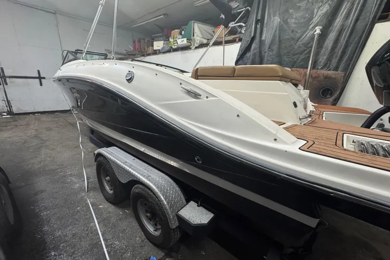 Slide: The Image of 2018 Sea Ray SPX 210 Outboard boat on trailer in garage setting. - 19