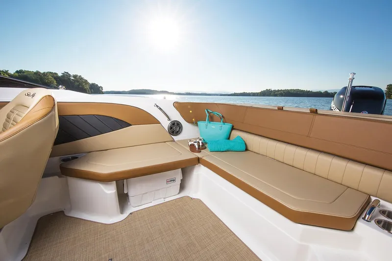Slide: The Image of Manufacturer Provided Image: Interior of 2018 Sea Ray SPX 210 OB boat with tan seating and blue sky. - 4