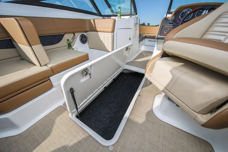 Slide: The Image of Manufacturer Provided Image: 2018 Sea Ray SPX 210 OB boat interior with tan seating and lake view. - 5