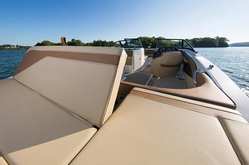 Slide: The Image of Manufacturer Provided Image: 2018 Sea Ray SPX 210 OB boat interior with beige seating and cup holders. - 7