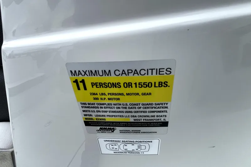 Slide: The Image of 2024 Crownline Eclipse E230 XS capacity label, max 11 persons or 1550 lbs. - 10
