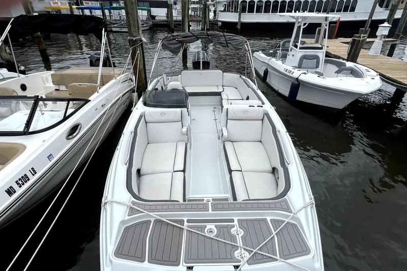 Slide: The Image of 2024 Crownline Eclipse E230 XS boat docked, featuring spacious seating and sleek design. - 4