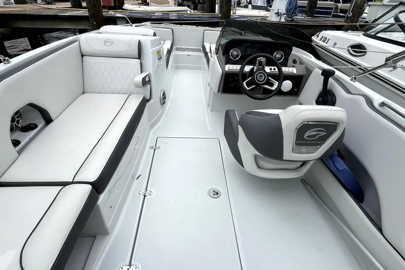 Slide: The Image of 2024 Crownline Eclipse E230 XS boat interior with sleek seating and modern dashboard design. - 7