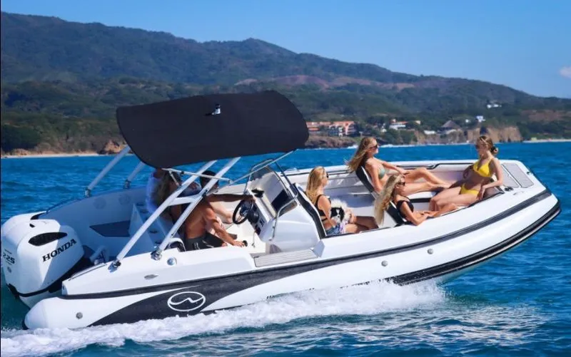 The Image of Manufacturer Provided Image: Walker Bay 22 boat cruising with passengers, 2025 model, on clear blue water. - 1