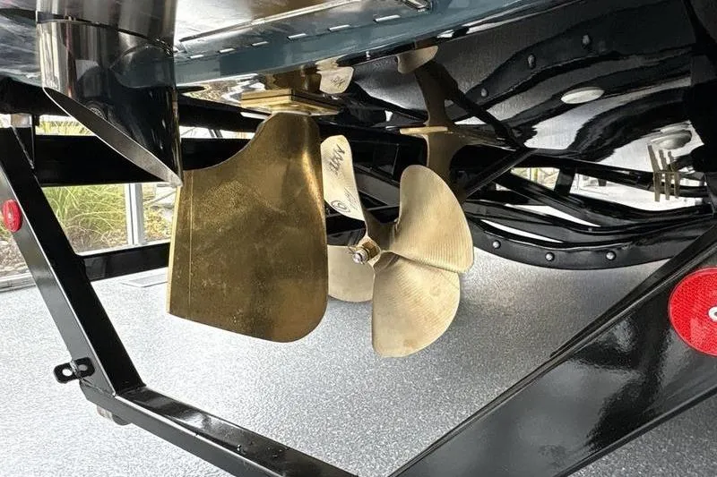 Slide: The Image of 2026 MasterCraft NXT22 boat propeller and rudder on a trailer. - 14