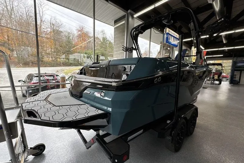 Slide: The Image of 2026 MasterCraft NXT22 boat displayed indoors, showcasing sleek design and modern features. - 2