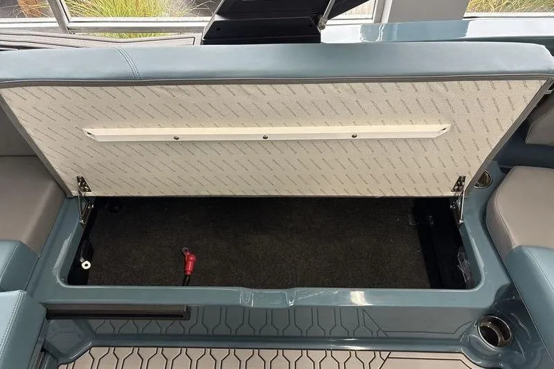 Slide: The Image of Open storage compartment in 2026 MasterCraft NXT22 boat interior. - 4