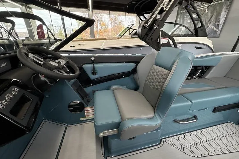 Slide: The Image of 2026 MasterCraft NXT22 boat interior with modern steering and seating design. - 9