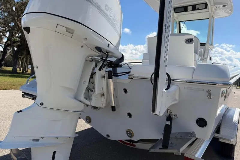 Slide: The Image of 2020 Everglades 253 Center Console boat with Yamaha outboard motor, parked outdoors. - 19