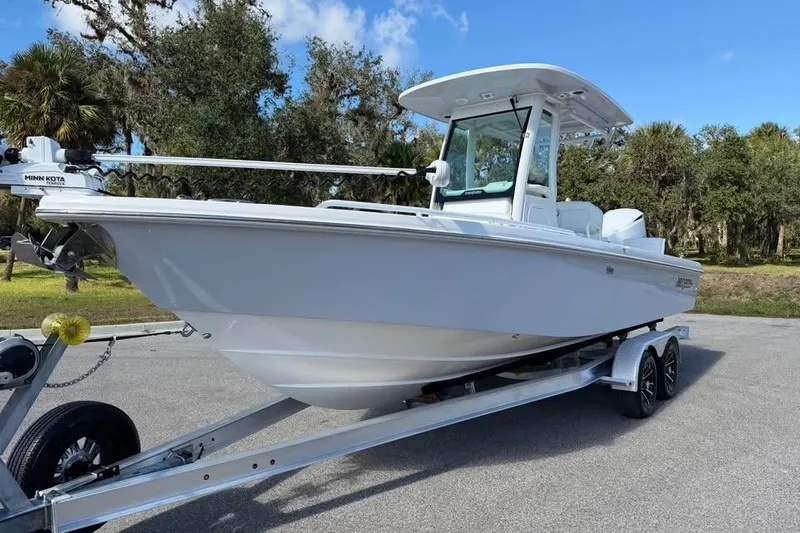 Slide: The Image of 2020 Everglades 253 Center Console boat on trailer, parked outdoors. - 2