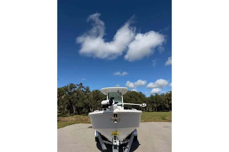 Slide: The Image of 2020 Everglades 253 Center Console boat on trailer under blue sky. - 3