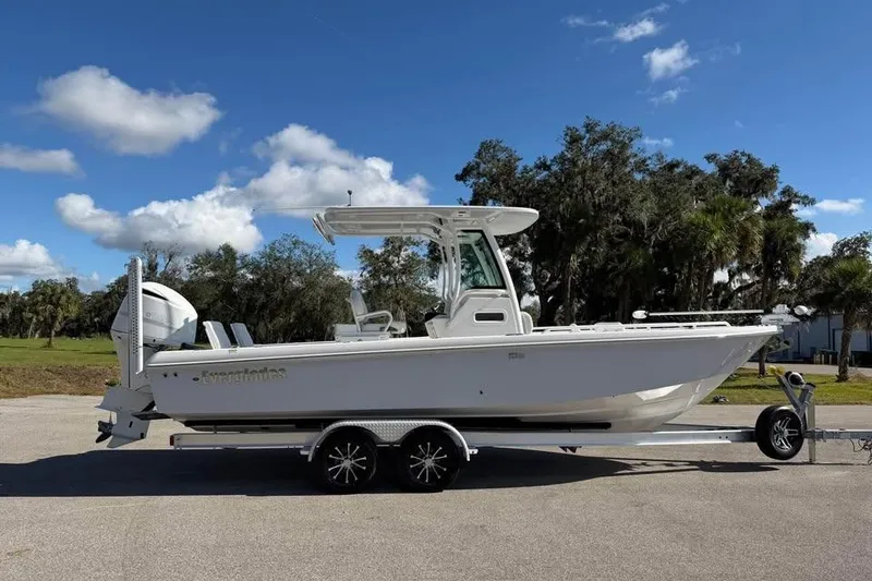 Slide: The Image of 2020 Everglades 253 Center Console boat on trailer under blue sky. - 4