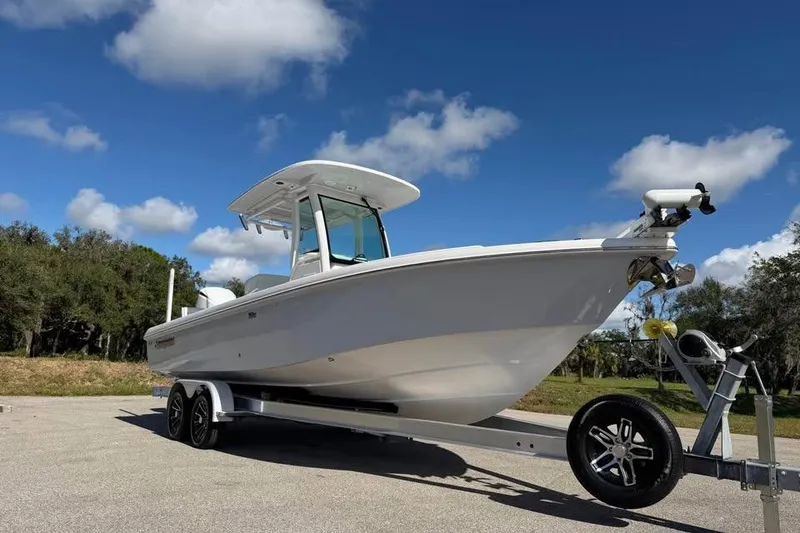 Slide: The Image of 2020 Everglades 253 Center Console boat on trailer under blue sky. - 5