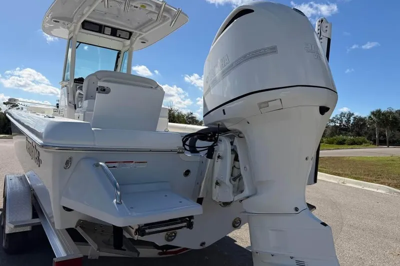 Slide: The Image of 2020 Everglades 253 Center Console boat with powerful outboard motor, parked on trailer. - 7