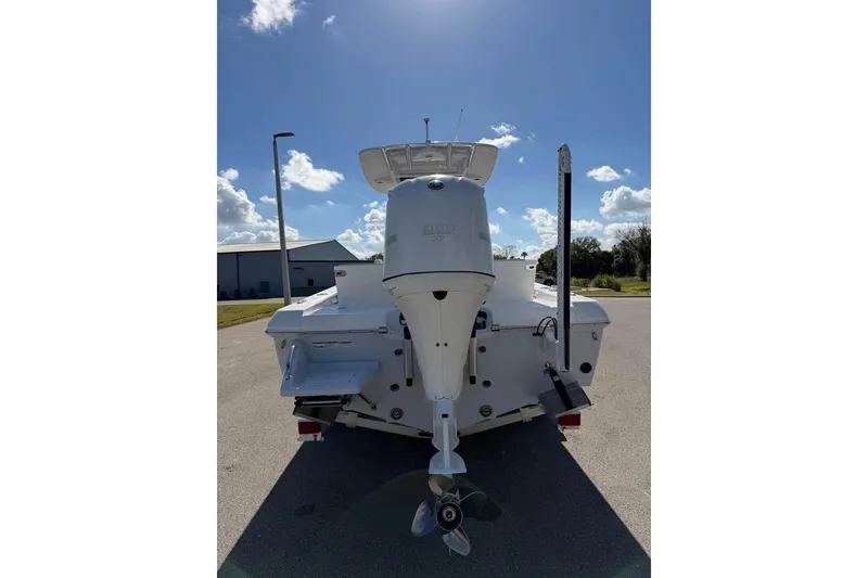 Slide: The Image of 2020 Everglades 253 Center Console boat, rear view with outboard motor, under clear sky. - 8