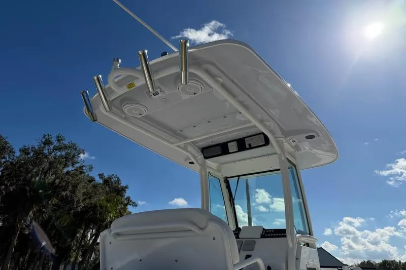 Slide: The Image of 2020 Everglades 253 Center Console boat under clear blue sky. - 9