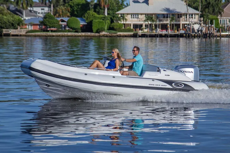 The Image of Manufacturer Provided Image: 2025 Walker Bay Generation 525 DLX boat cruising on a calm lake. - 0