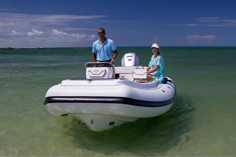 Slide: The Image of Manufacturer Provided Image: Walker Bay Generation 525 DLX 2025 boat on clear water with two people onboard. - 4