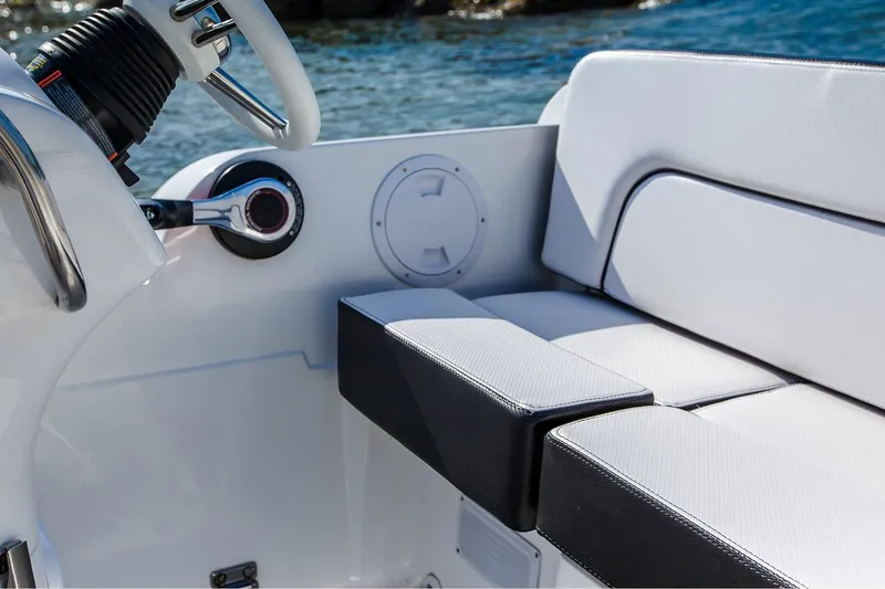 Slide: The Image of Manufacturer Provided Image: Walker Bay Generation 525 DLX 2025 boat interior with white seating and steering wheel. - 8
