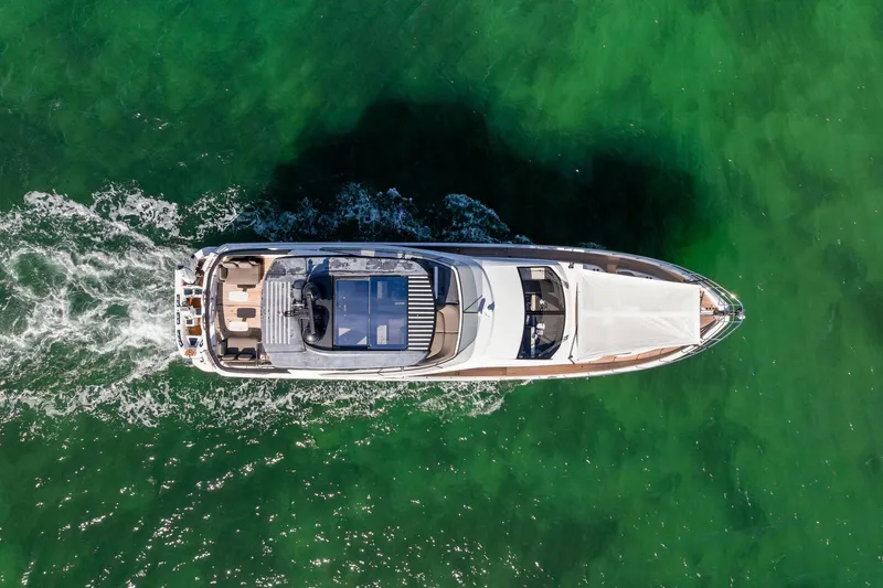 Slide: The Image of Top view of 2021 Azimut Fly 78 yacht cruising on vibrant green water. - 11