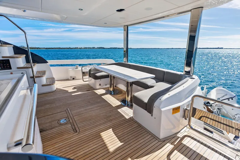 Slide: The Image of Luxurious 2021 Azimut Fly 78 yacht deck with seating, overlooking serene ocean waters. - 23