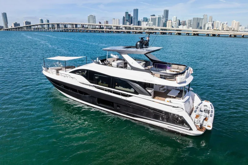 Slide: The Image of Luxurious 2021 Azimut Fly 78 yacht cruising near a city skyline. - 6