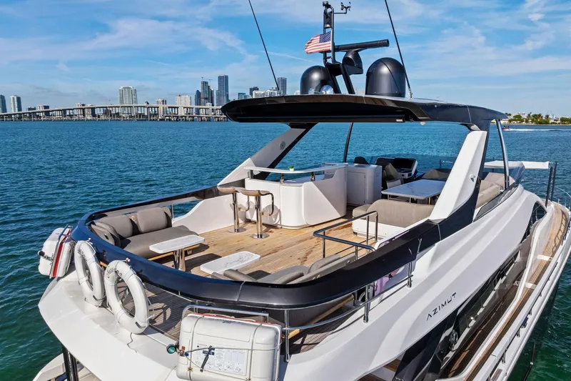 Slide: The Image of Luxurious 2021 Azimut Fly 78 yacht with spacious deck, city skyline in background. - 63