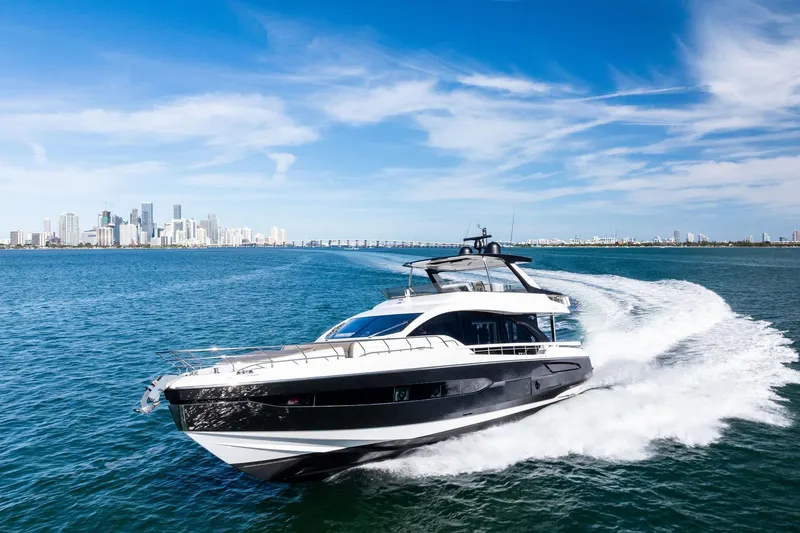 Slide: The Image of 2021 Azimut Fly 78 yacht cruising near city skyline under clear blue sky. - 71