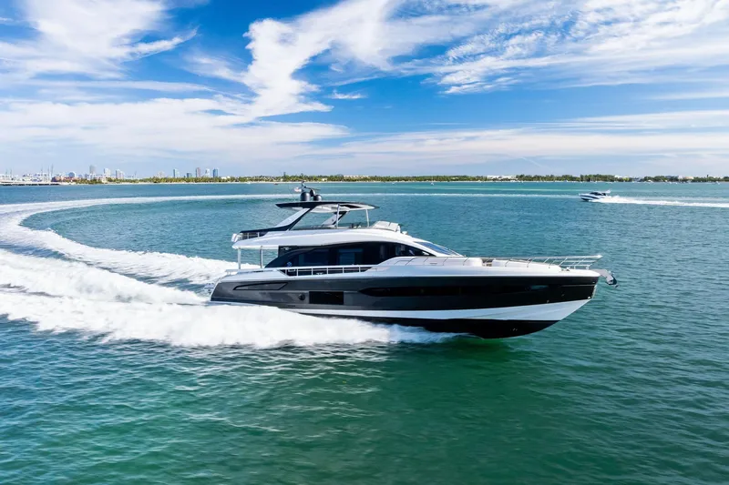 Slide: The Image of 2021 Azimut Fly 78 yacht cruising on open water under a clear blue sky. - 73