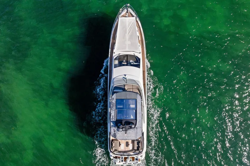 Slide: The Image of Aerial view of 2021 Azimut Fly 78 yacht cruising on vibrant green water. - 74