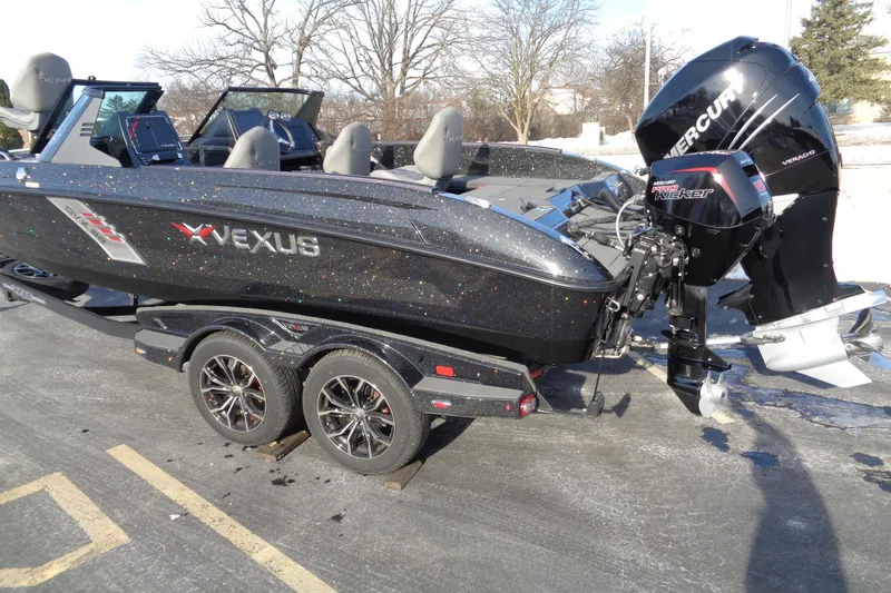 Slide: The Image of 2022 Vexus DVX 22 boat with Mercury engine on a trailer, parked outdoors. - 10