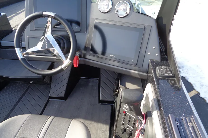 Slide: The Image of 2022 Vexus DVX 22 boat dashboard with steering wheel and digital displays. - 25