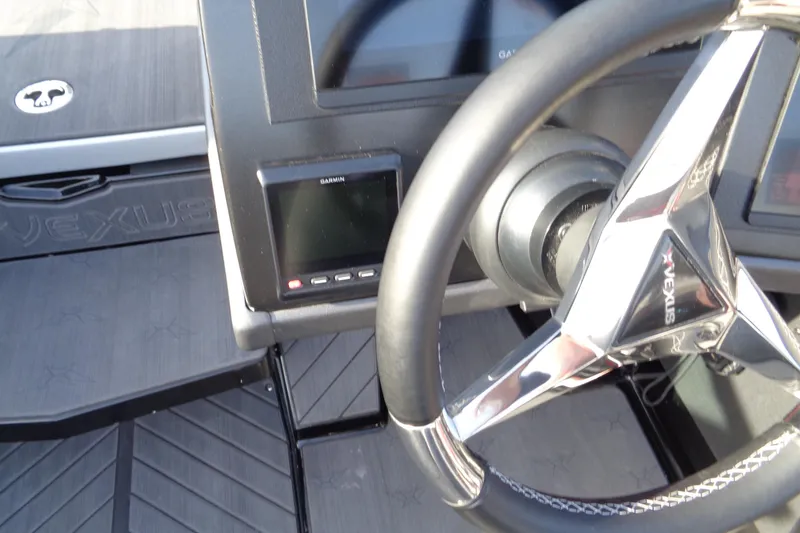 Slide: The Image of 2022 Vexus DVX 22 boat dashboard with steering wheel and Garmin display. - 28
