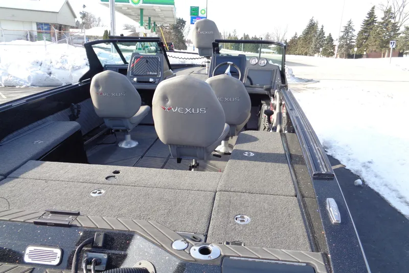 Slide: The Image of 2022 Vexus DVX 22 boat interior with gray seating, parked near snowy area. - 31