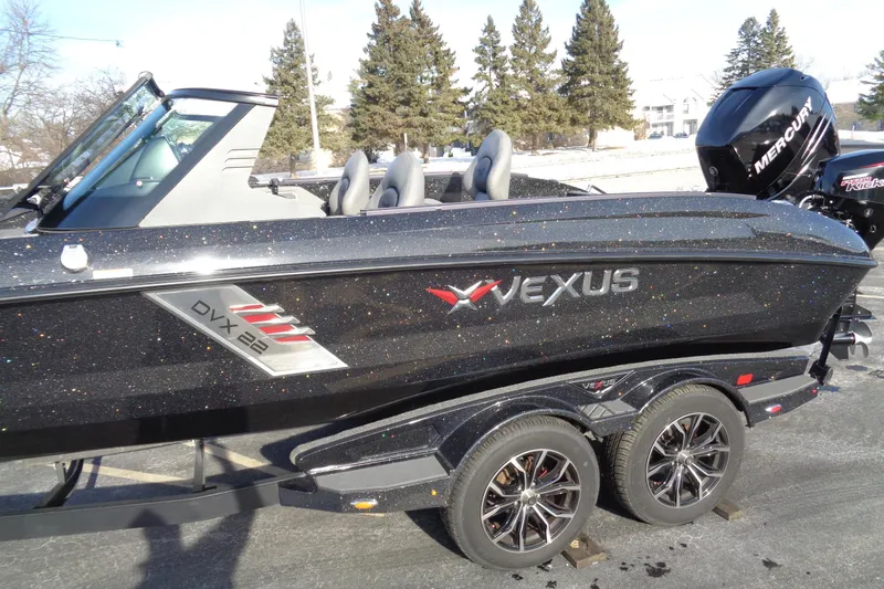 Slide: The Image of 2022 Vexus DVX 22 boat with glittering black finish and Mercury engine on trailer. - 4