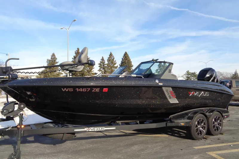 Slide: The Image of 2022 Vexus DVX 22 boat on trailer, parked outdoors under clear blue sky. - 40