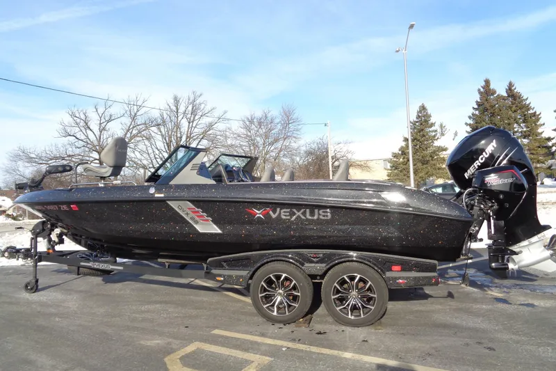 Slide: The Image of 2022 Vexus DVX 22 boat with Mercury engine on trailer, parked outdoors. - 43
