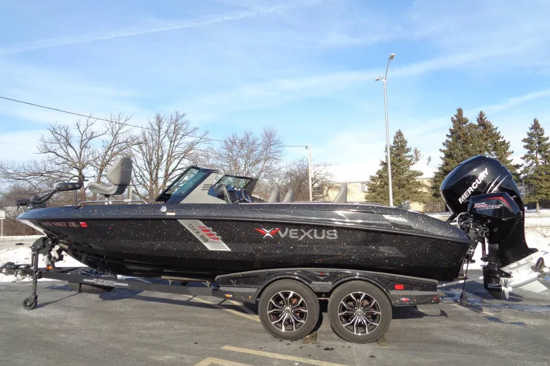Slide: The Image of 2022 Vexus DVX 22 boat with Mercury engine on trailer, parked outdoors. - 9