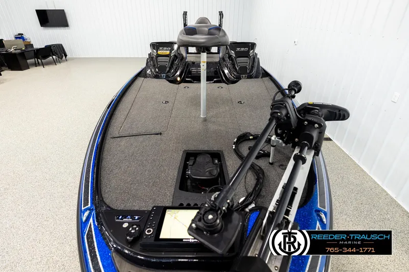 Slide: The Image of 2024 Bass Tracker Nitro Z20 boat in showroom, featuring advanced navigation equipment. - 15